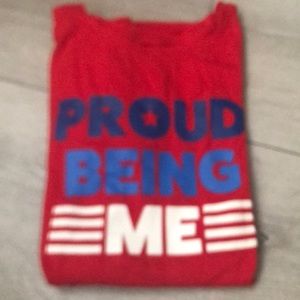 a shirt that is red and it says proud to be me